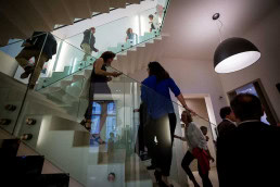 Guests go up and down stairs during an art exhibition event by Sotheby's in Brussels