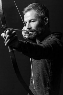 Black and white portrait of man with a bow