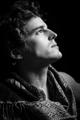 Black and white profile portrait of dark-haired young man looking away