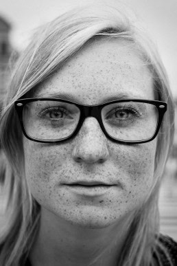 Black and white closeup portrait of a woman with glasses from Germany taken in Brussels