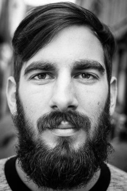 Black and white closeup portrait of a man with a beard from Italy taken in Brussels