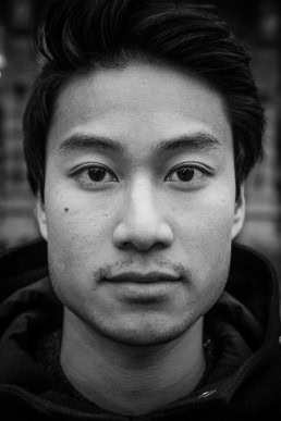 Black and white closeup portrait of a man from Vietnam taken in Brussels