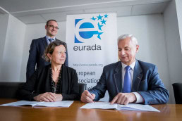 Former and current president of EURADA signing a document during a meeting in Brussels