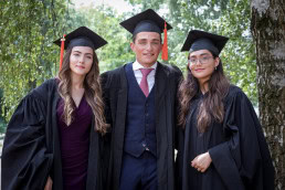 A group of 3 Vesalius College bachelors pose in their graduation day in Brussels