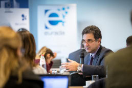 Closeup of a guest from the audience while asking a question with a microphone