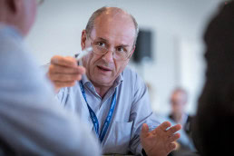 Closeup of a man pointing with his hand during a networking event in Brussels