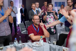 JS World Media CEO Jens Stausholm is applauded before receiving a prize during an event in Brussels