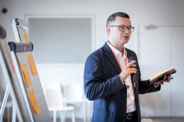 A man addressing the audience while giving a presentation in Brussels
