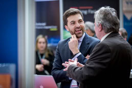 Closeup of a man networking during the 2018 CS International Conference in Brussels