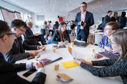 A round table of people doing a network activity during a conference in Brussels