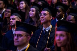 Vesalius College students awaiting in the audience during their graduation day