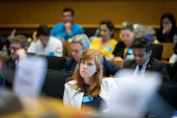 A woman from the audience listens carefully during the EPP Group conference in Brussels