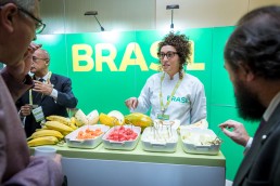 Fruit importer presenting her produce during an event for APEX Brasil