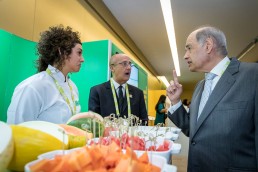 A visitor engaging the fruit importer at her stand during an event for APEX Brasil in Brussels