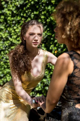 Fashion portrait of girl with golden dress under the sunlight
