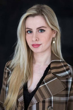 Portrait of a blond girl with earrings and red lips