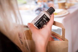 A hand from a volunteer checking a product from Lush during the Animal Rights volunteers party