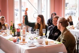 A volunteer raises her hand playing quiz during the Animal Rights volunteers party