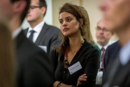 A guest woman listens to a speech during the Stellenbosch University cocktail at the South African Embassy, Brussels