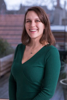 Portrait of a woman wearing a green dress for ECOS in Brussels