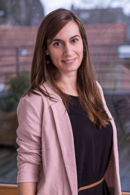 Corporate portrait of a woman wearing a pink jacket for ECOS in Brussels
