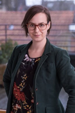 Portrait of a woman wearing a green jacket for ECOS in Brussels