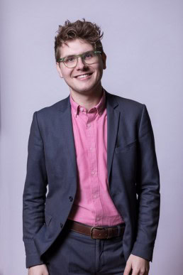 Corporate Portrait of a man wearing a pink shirt for ECOS in Brussels