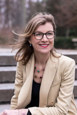 Portrait of Birgitta Bechtold wearing a light brown jacket at Leopold Park, Brussels
