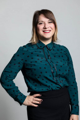 Corporate portrait of a woman wearing a green shirt with black polka dots for the European Social Network