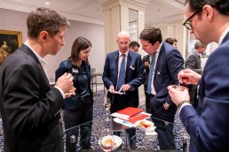 Attendees in a circle talk and network at the end of the conference during the GC Summit Belgium 2020