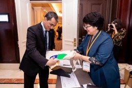 An attendee gets a goodie bag when registering during the 9th meeting of the WGECC in Brussels