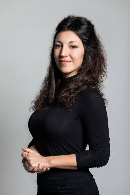Corporate portrait of a woman wearing a black long sleeve shirt for the European Social Network