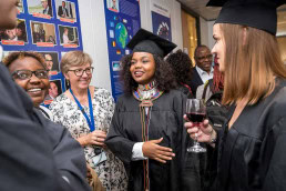 An African girl after her bachelorette from the Institute for European Studies talking to friends