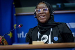 An African woman smiles while she speaks at the European Parliament during the 2019 Youth Week