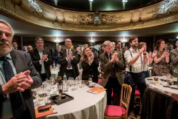 The audience stands up and applauds during an award ceremony in Brussels