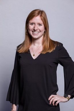 Corporate portrait of a ginger woman wearing a dark blouse for Berquin Notarissen in Brussels	