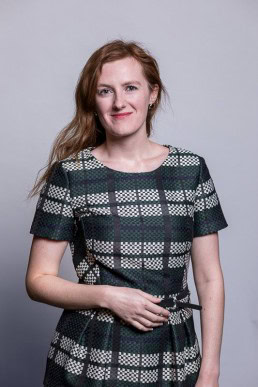 Corporate portrait of a woman wearing a patterned green dress for Berquin Notarissen in Brussels	