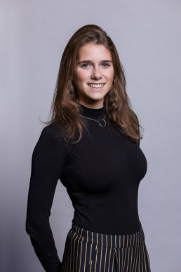 Corporate portrait of a woman smiling wearing a black sweater and necklace for Berquin Notarissen in Brussels	