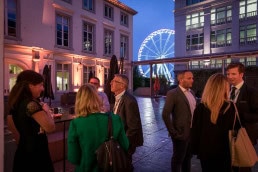 A ferris wheel is seen from the Cercle de Lorraine in Brussels during an event at dusk