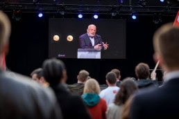 Frans Timmermans is seen on a screen at the EU Parliament during the 2019 Youth Week in Brussels