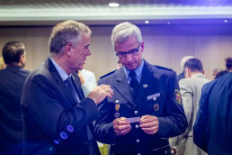 Two men exchange business cards during the EU Road Safety Exchange conference in Brussels