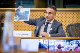 Syed Hasnain shows a picture while speaking at the European Parliament