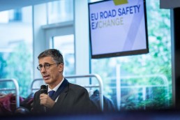 A man wearing glasses poses a question during the 2019 EU Road Safety Exchange Conference in Brussels