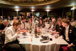 Guests sitting on tables at the Vaudeville Theatre during the 2019 Excellence in Road Safety Awards