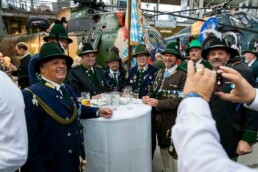 Men dressed in typical Bavarian customs posing for a photo