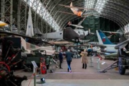Three people walking down the Royal Museum of Armed Forces in Brussels