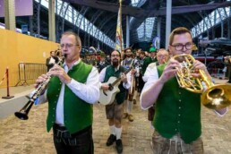 A music band dressed in typical Bavarian customs playing and marching out of the Royal Museum of Armed Forces in Brussels