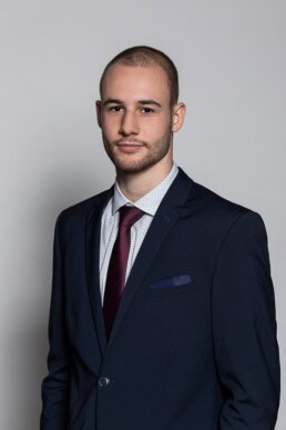 Portrait of a man wearing a tuxedo and dark violet tie for Berquin Notarissen in Brussels