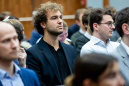 A man watches with attention while a person makes a presentation