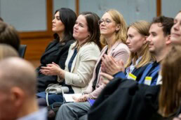 A group of women sitting applaud during the Industrial Single Market event organized by Bosch in Brussels